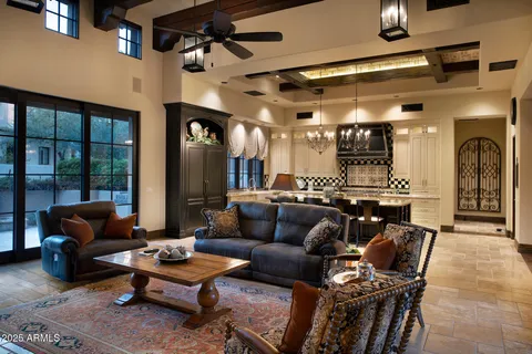 a living room with furniture a rug and a chandelier