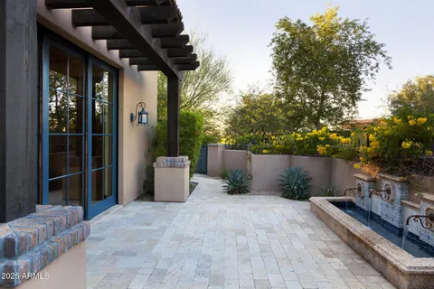 a view of a chairs and table in backyard