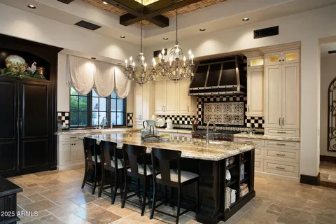 a kitchen with cabinets and chairs