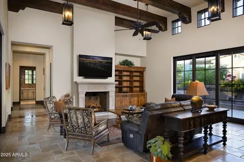 a living room with furniture a fireplace and a flat screen tv