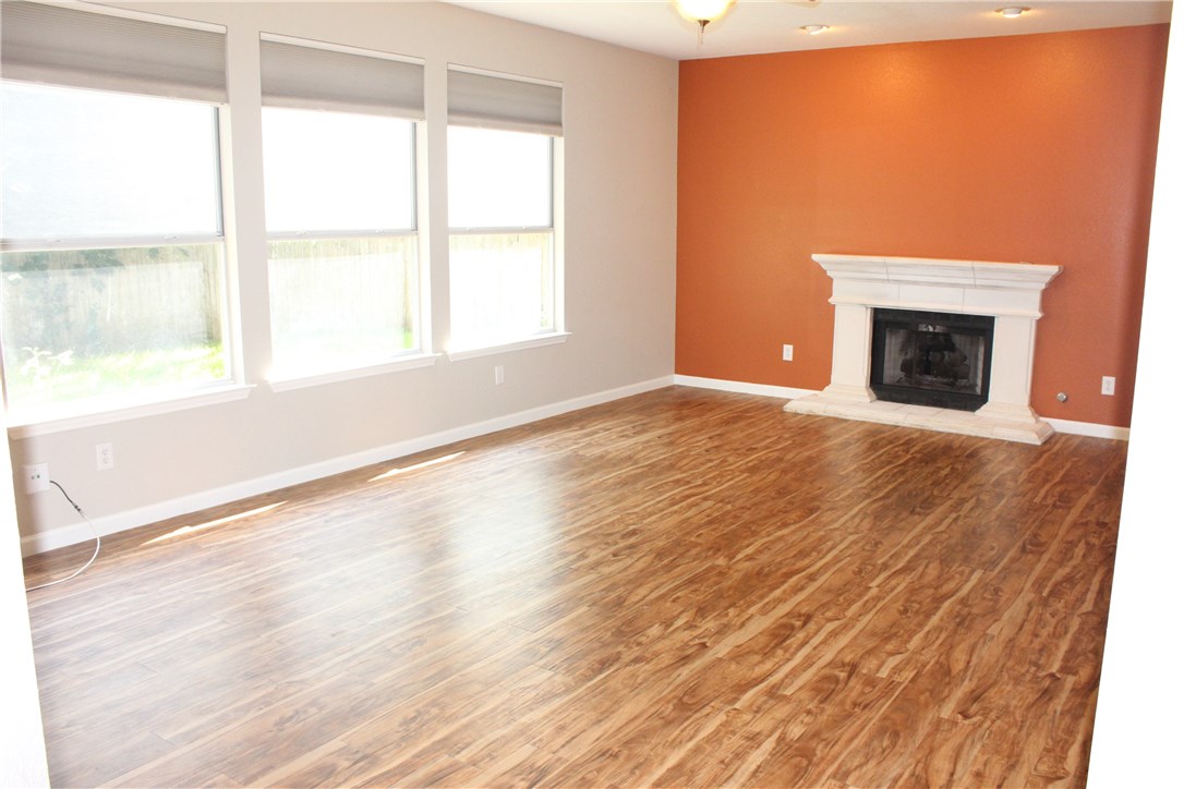 7801 Varcella Trail Austin, TX 78729 - Photo 3 of 26 a view of an empty room with wooden floor and a window