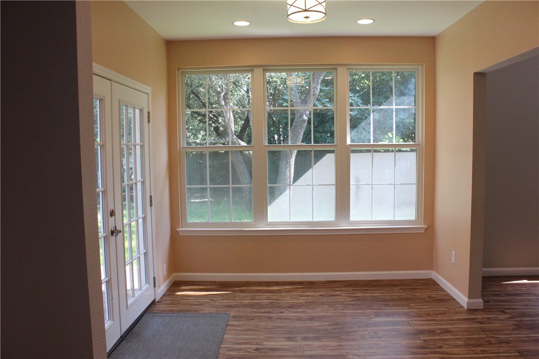 7801 Varcella Trail Austin, TX 78729 - Photo 8 of 26 an empty room with wooden floor and windows