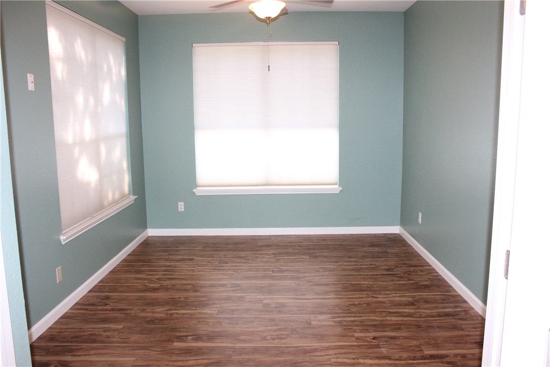 7801 Varcella Trail Austin, TX 78729 - Photo 9 of 26 a view of an empty room with wooden floor and a window