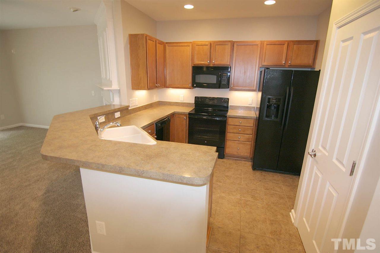 8614 Redcrest Place Raleigh, NC 27617 - Photo 2 of 16 a kitchen with granite countertop a refrigerator and a sink