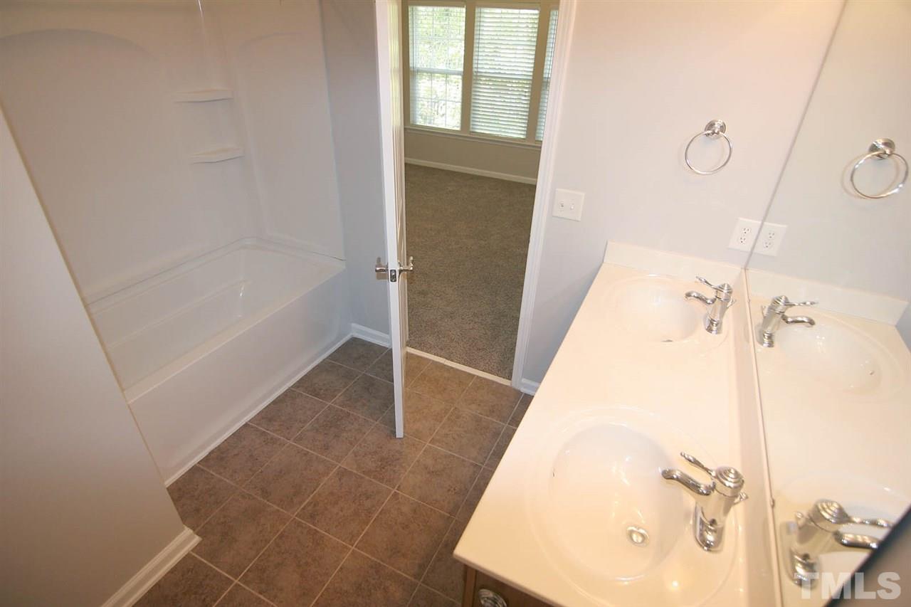 8614 Redcrest Place Raleigh, NC 27617 - Photo 11 of 16 a bathroom with a bathtub and a shower