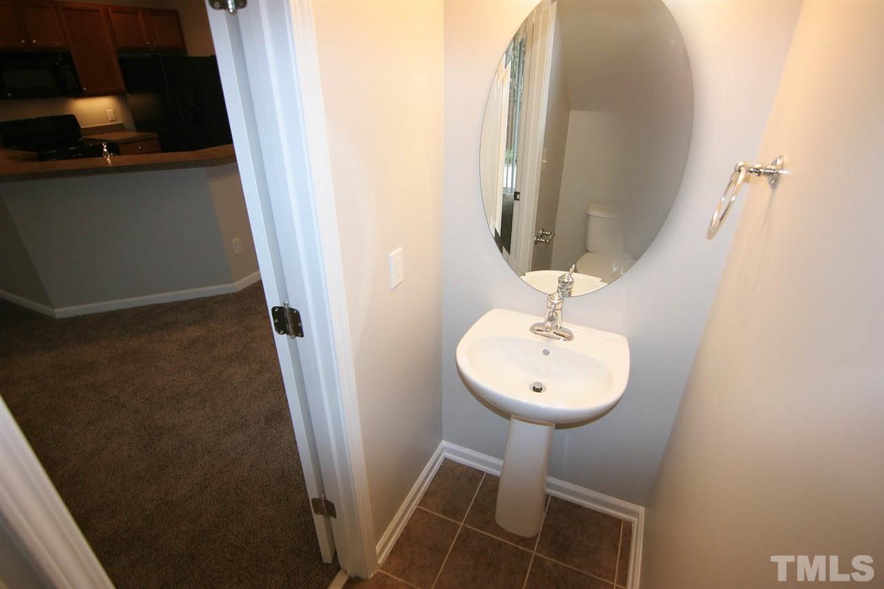 8614 Redcrest Place Raleigh, NC 27617 - Photo 8 of 16 a bathroom with a sink a mirror and a light fixture