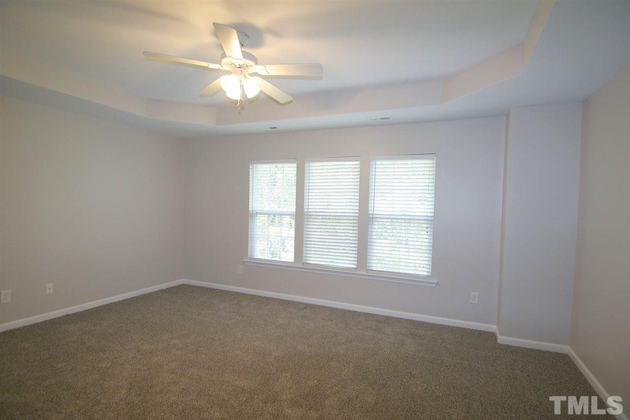 8614 Redcrest Place Raleigh, NC 27617 - Photo 9 of 16 an empty room with a window and a ceiling fan