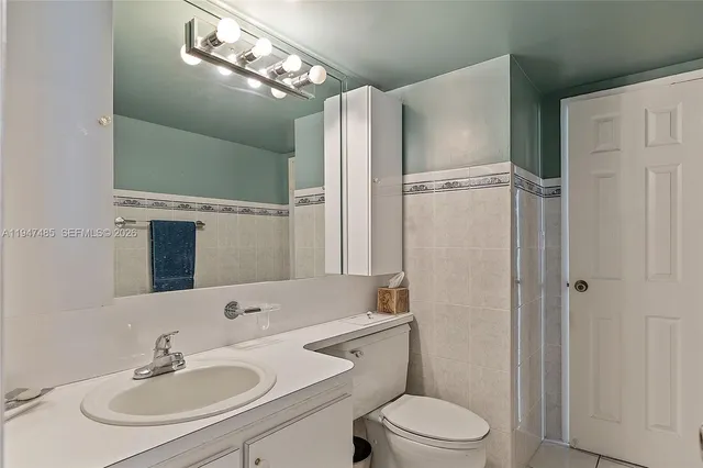 a view of bathroom with a sink mirror and shower
