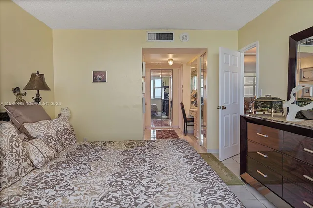 a bathroom with a glass door shower and a sink