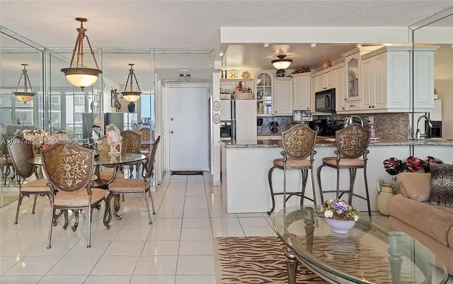 a view of a kitchen with dining table and chairs