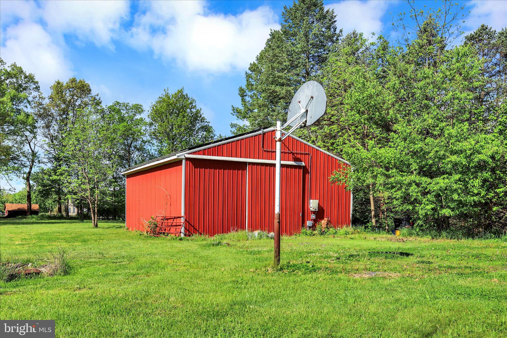 620 St Johns Road Littlestown, PA 17340 - Photo 21 of 25 a backyard of a house with plants and large trees