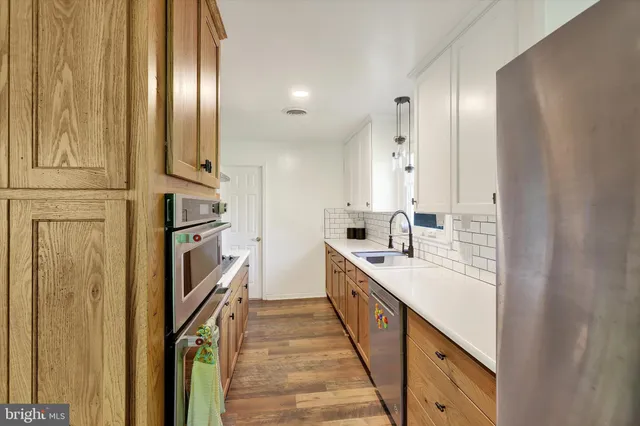 a bathroom with double vanity and mirrors