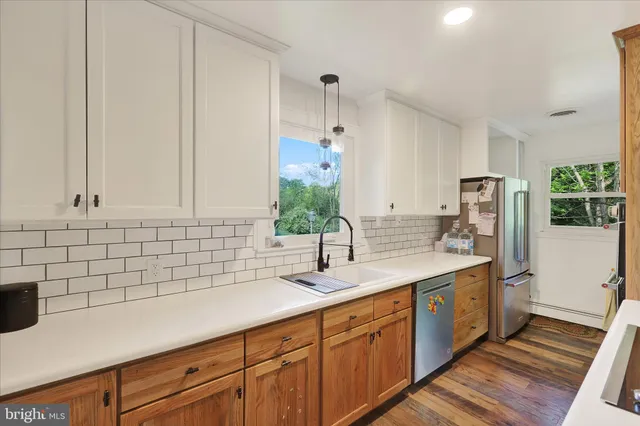 a kitchen with sink cabinets and wooden floor