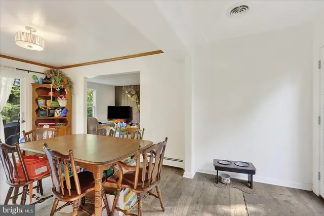 a dining room with furniture and window