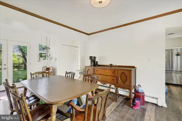 a view of a dining room with furniture and chandelier
