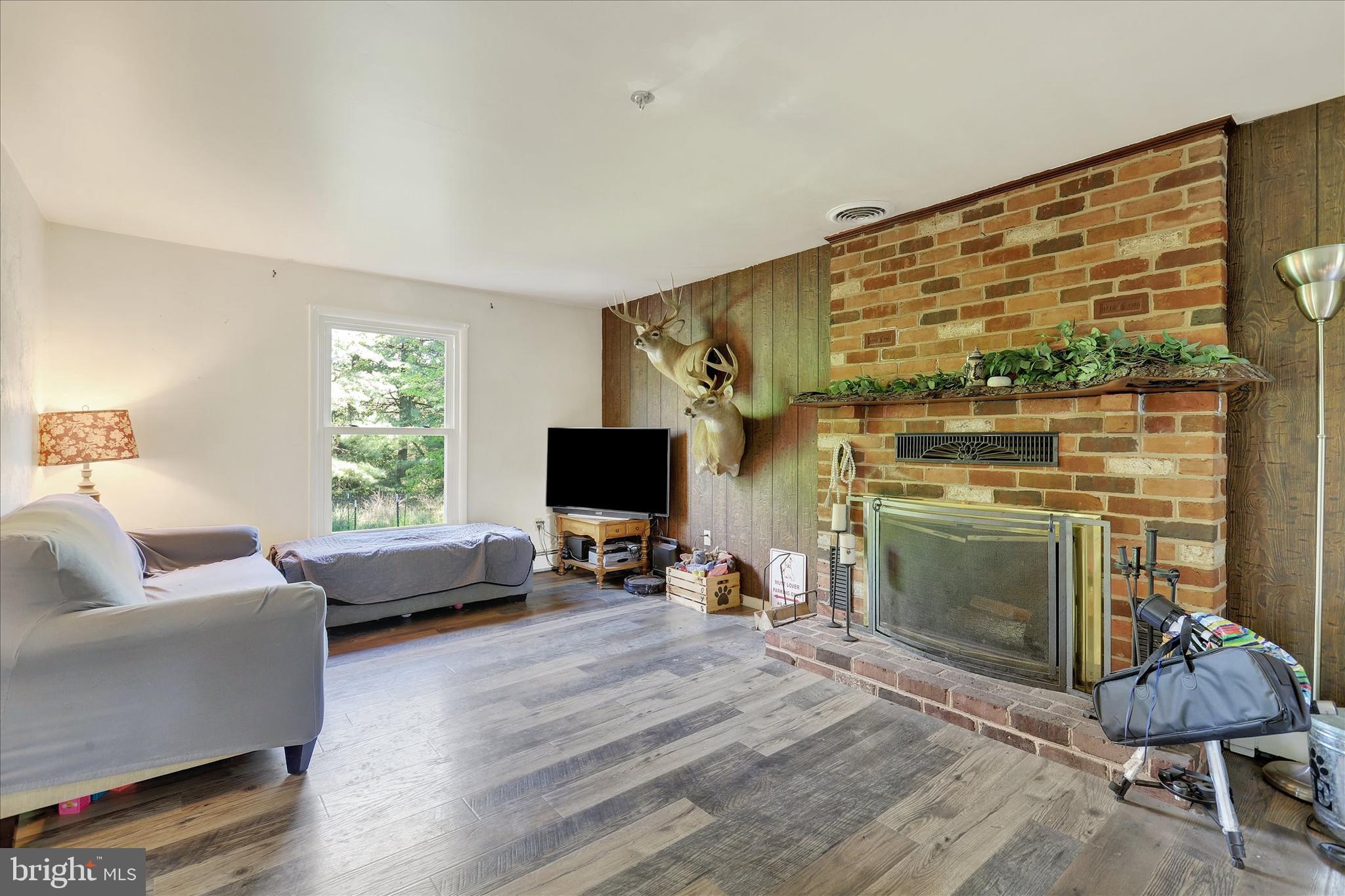 620 St Johns Road Littlestown, PA 17340 - Photo 9 of 25 a living room with furniture a fireplace and a flat screen tv