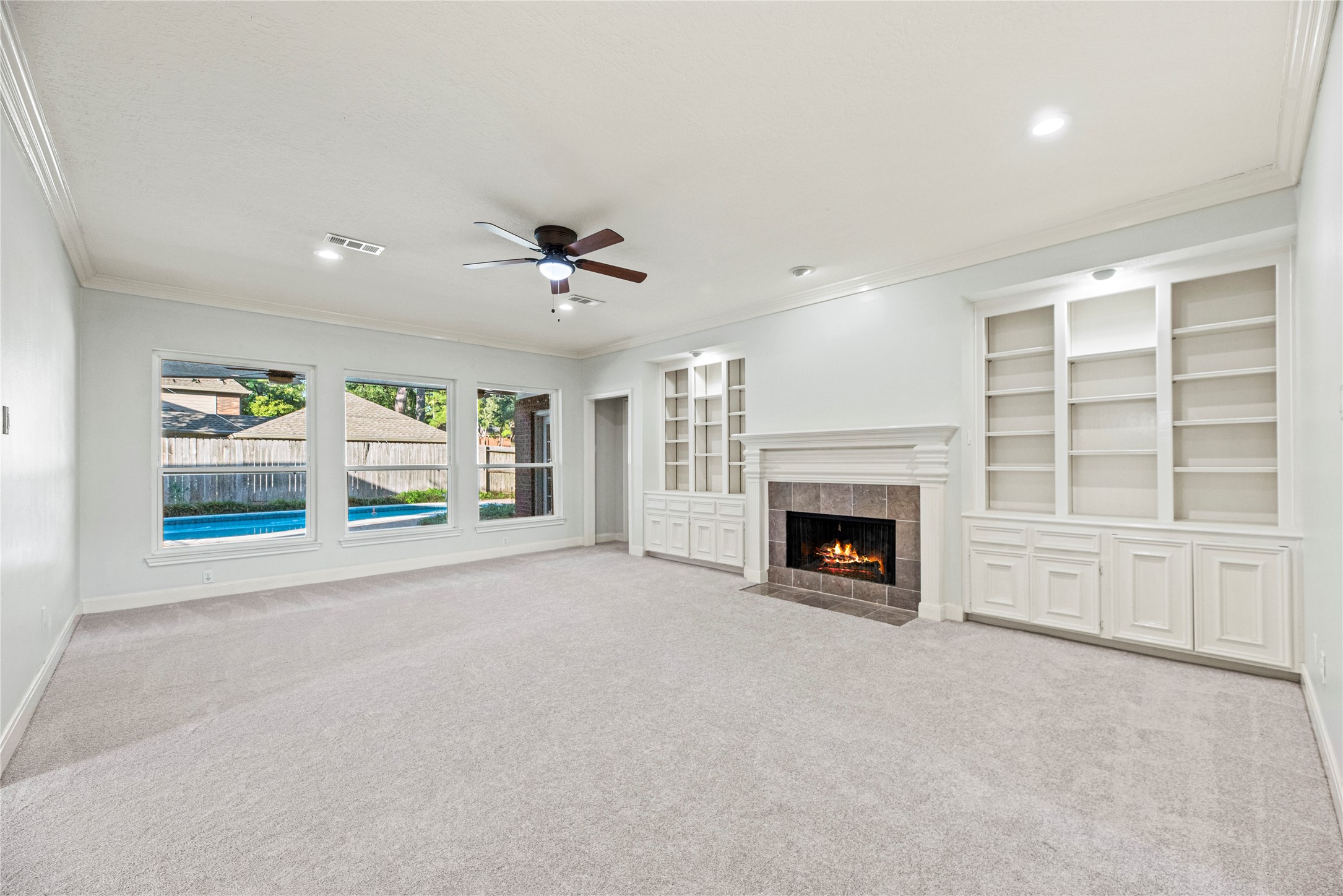 12502 Pavilion Court Tomball, TX 77377 - Photo 15 of 37 Spacious family room with a cozy fireplace surrounded by custom built-ins and new carpeting.