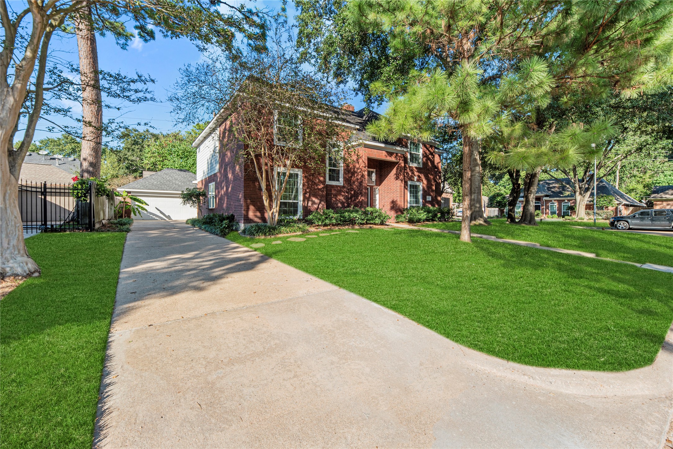 12502 Pavilion Court Tomball, TX 77377 - Photo 2 of 37 2-car detached garage and long driveway. Grass has been digitally enhanced to show potential.