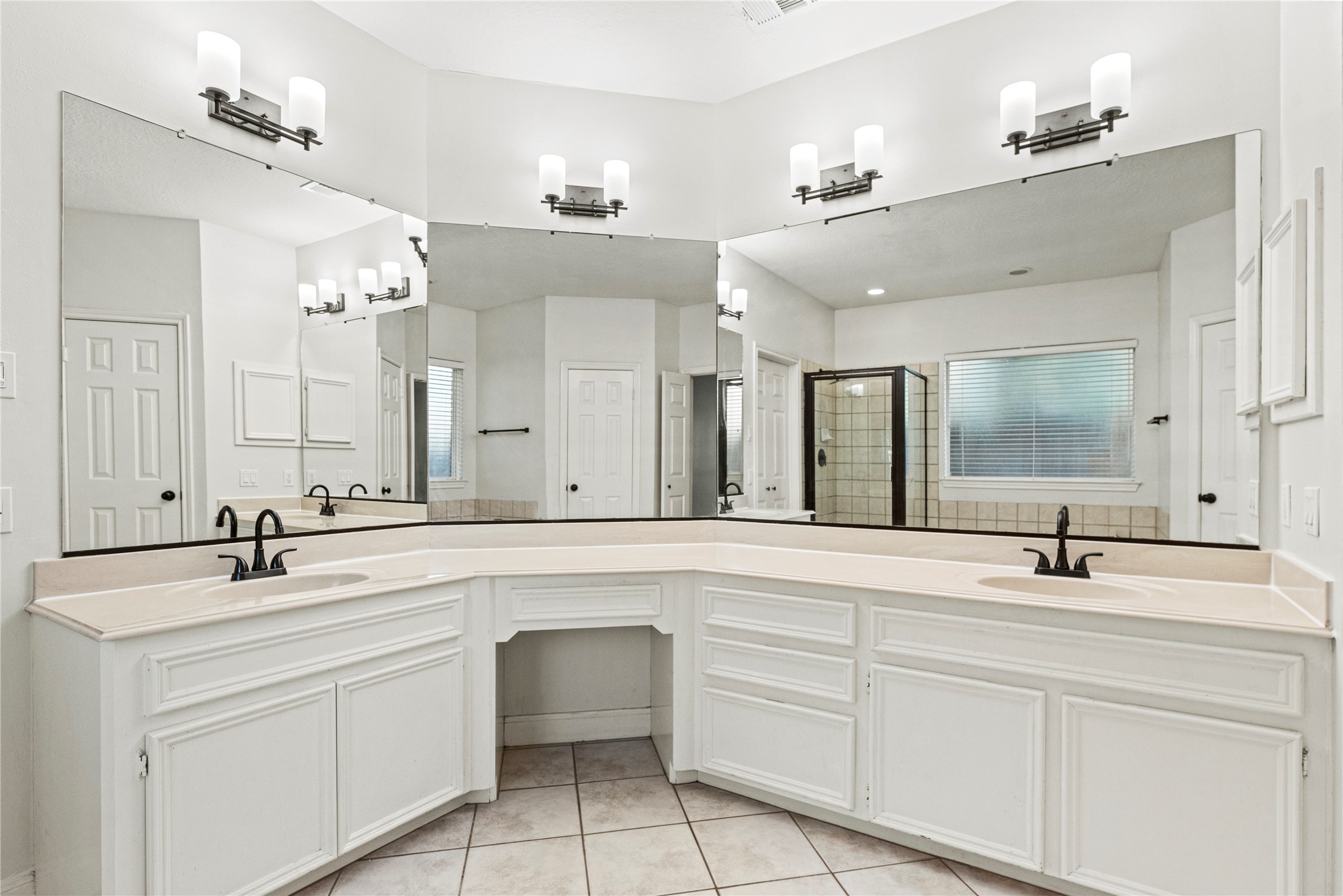 12502 Pavilion Court Tomball, TX 77377 - Photo 22 of 37 Spa-like primary bathroom includes a large, dual sink vanity, jetted tub and separate shower.