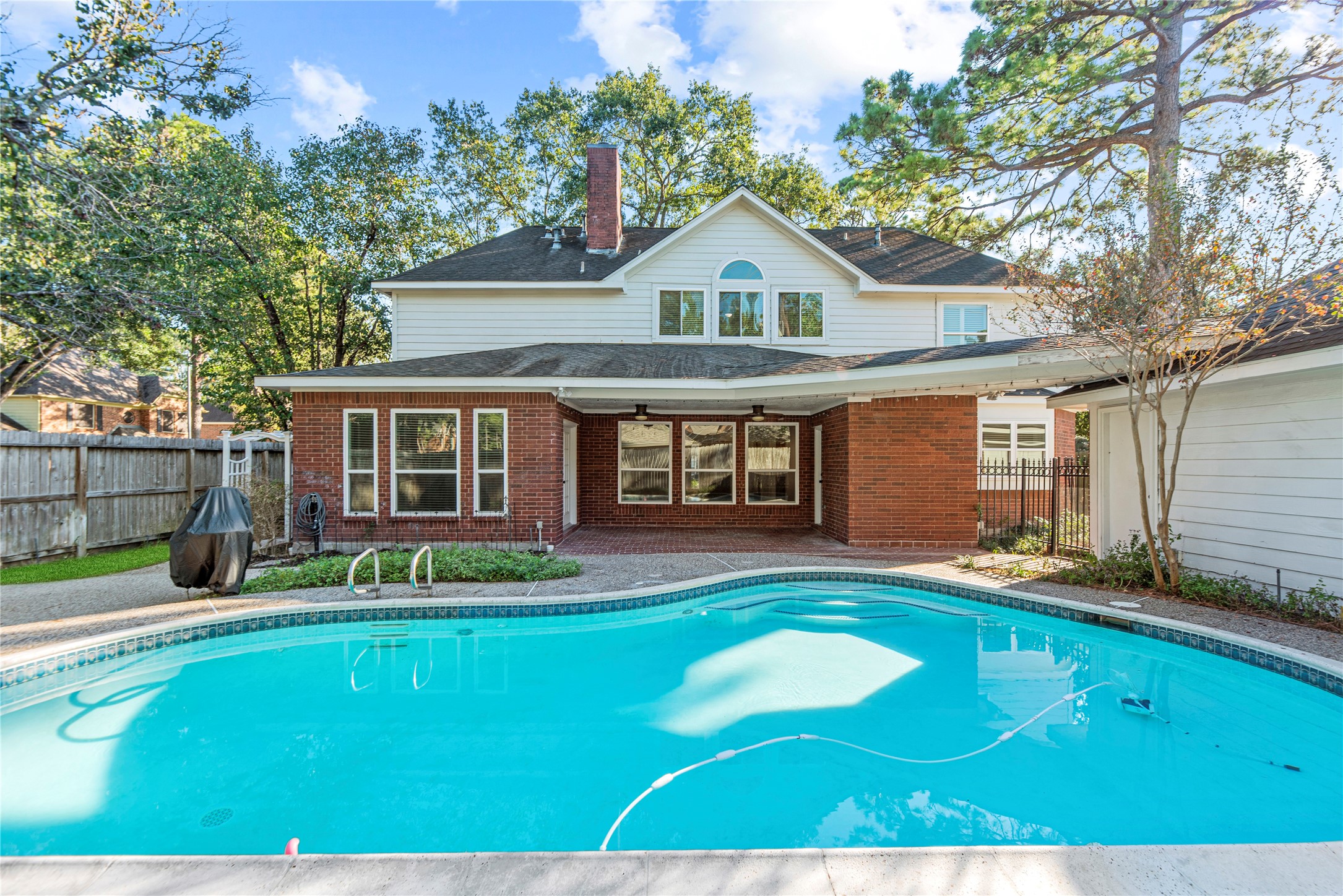 12502 Pavilion Court Tomball, TX 77377 - Photo 35 of 37 Amazing backyard with a covered patio and sparkling pool.