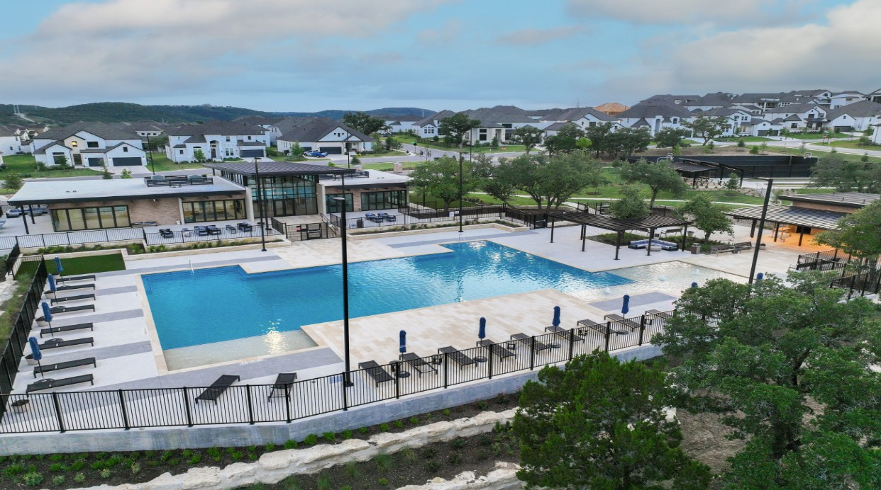 1912 Montella Way Leander, TX 78641 - Photo 24 of 31 a view of a swimming pool with outdoor seating and a lake view