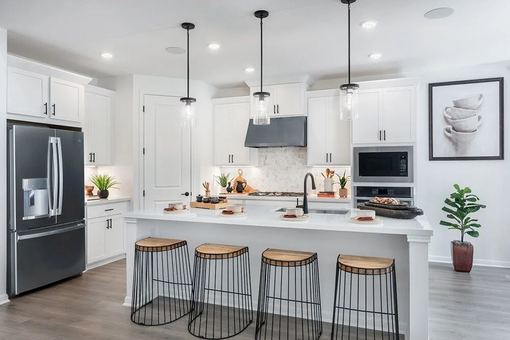 1912 Montella Way Leander, TX 78641 - Photo 5 of 31 a kitchen with stainless steel appliances kitchen island granite countertop a stove a sink and a refrigerator