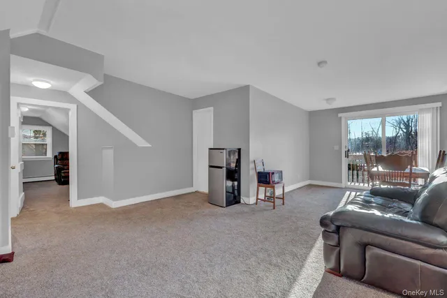 a living room with furniture and a floor to ceiling window