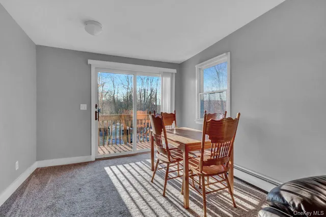 a dining room with furniture and wooden floor