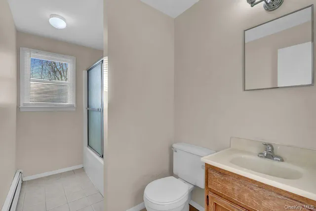 a bathroom with a sink toilet and mirror