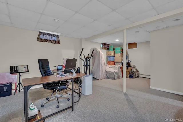 a view of a workspace with furniture and a ceiling fan