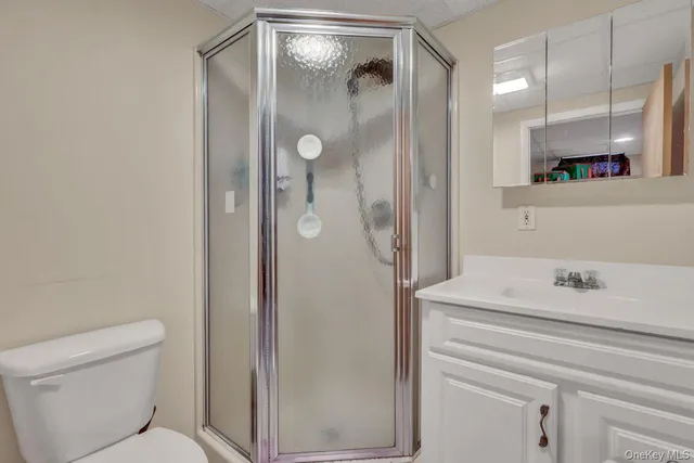 a bathroom with a shower a sink and a toilet