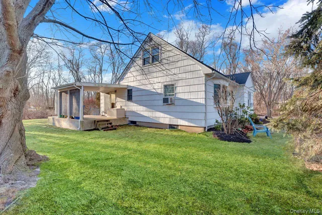 a view of a house with a yard and deck