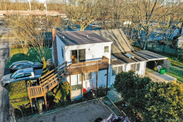 a aerial view of a house with a yard and potted plants
