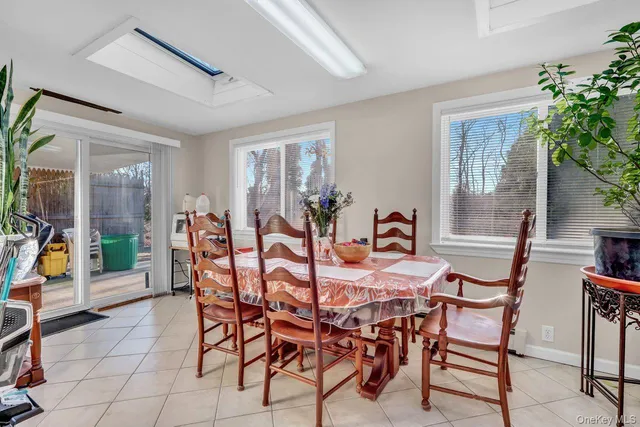 a view of a dining room with furniture and a potted plant
