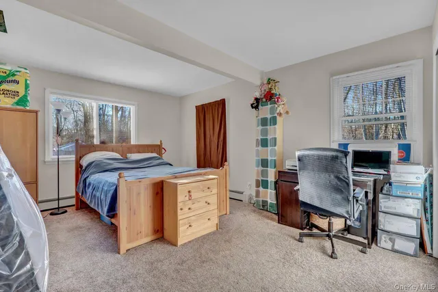 a bedroom with bed and window