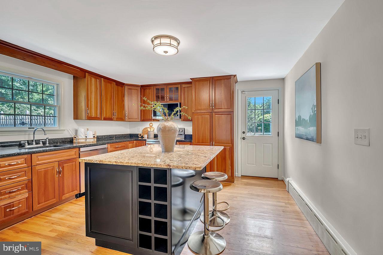 513 Cherry Valley Road Princeton, NJ 08540 - Photo 24 of 52 a view of a kitchen with granite countertop a sink appliances cabinets and a window