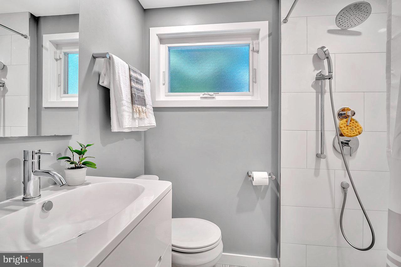 513 Cherry Valley Road Princeton, NJ 08540 - Photo 29 of 52 a bathroom with a sink vanity mirror and toilet