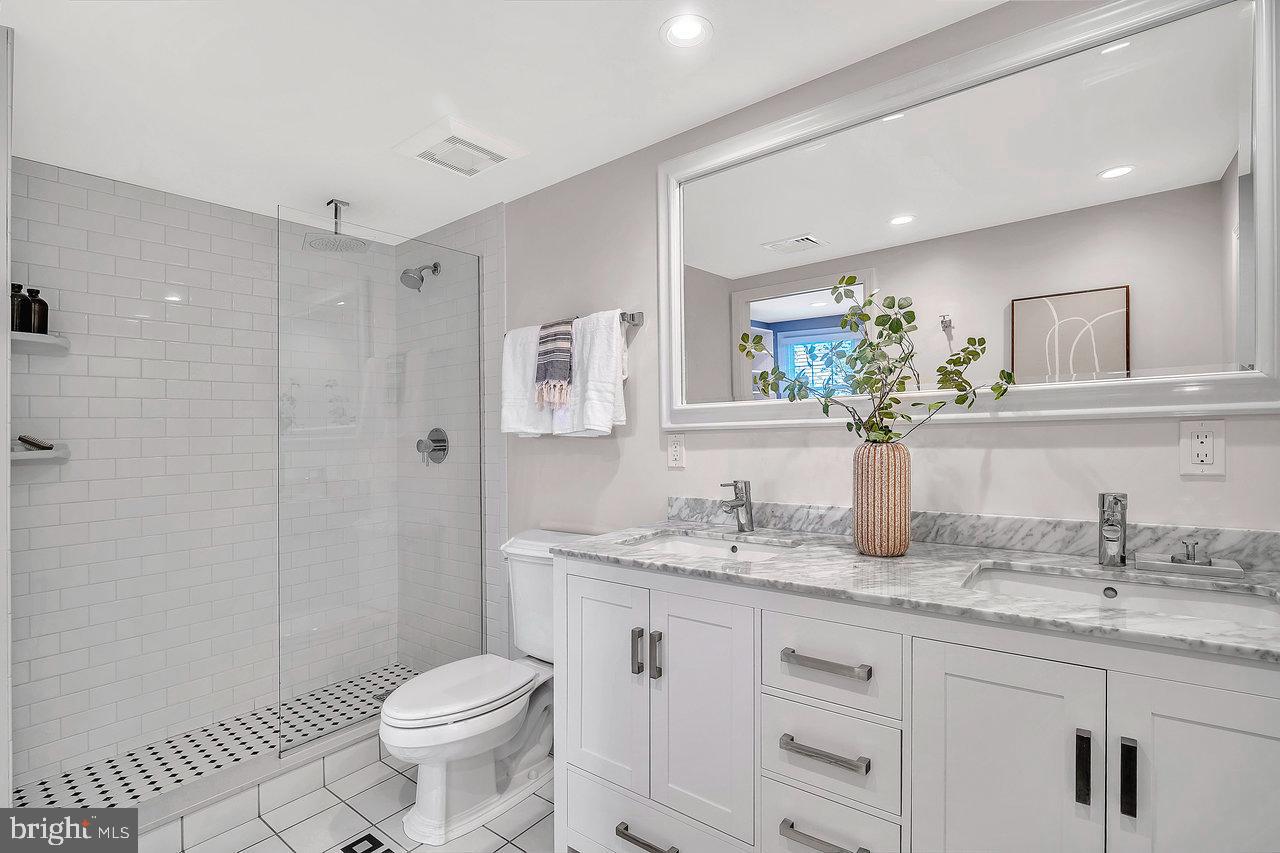 513 Cherry Valley Road Princeton, NJ 08540 - Photo 38 of 52 a bathroom with a granite countertop sink toilet and shower