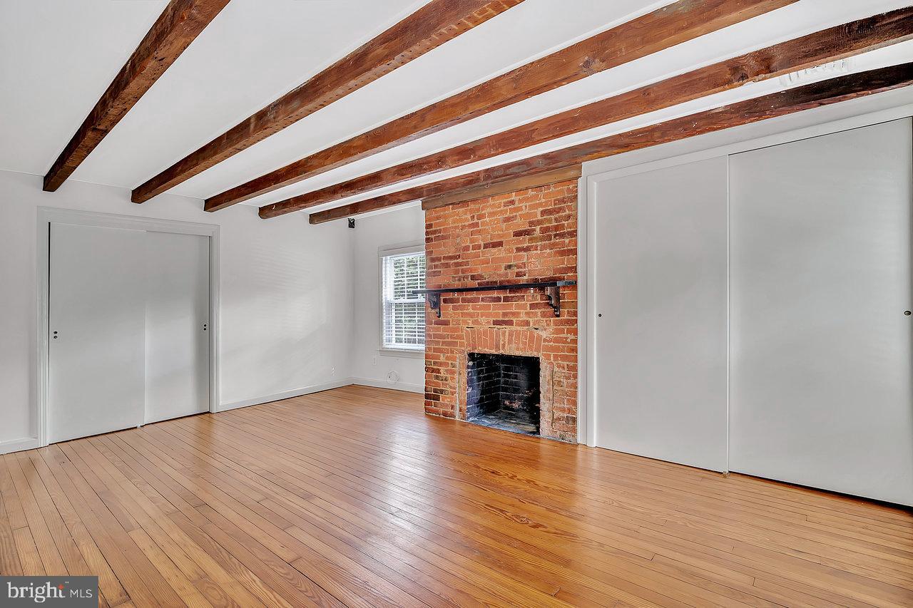 513 Cherry Valley Road Princeton, NJ 08540 - Photo 44 of 52 a view of an empty room with wooden floor fireplace and a window