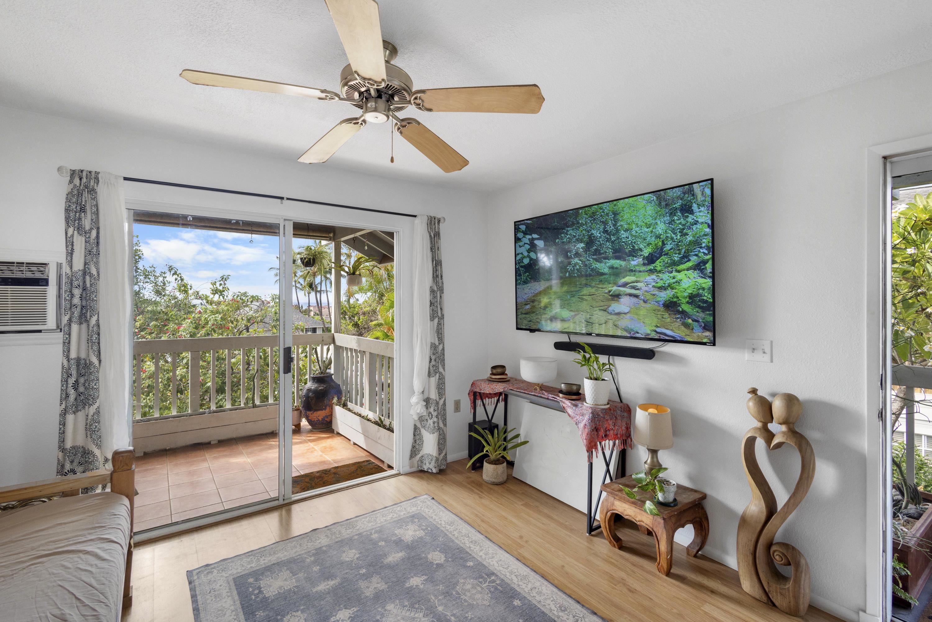 160 Keonekai Road, Unit 22201 Kihei, HI 96753 - Photo 2 of 37 a living room with furniture and a flat screen tv