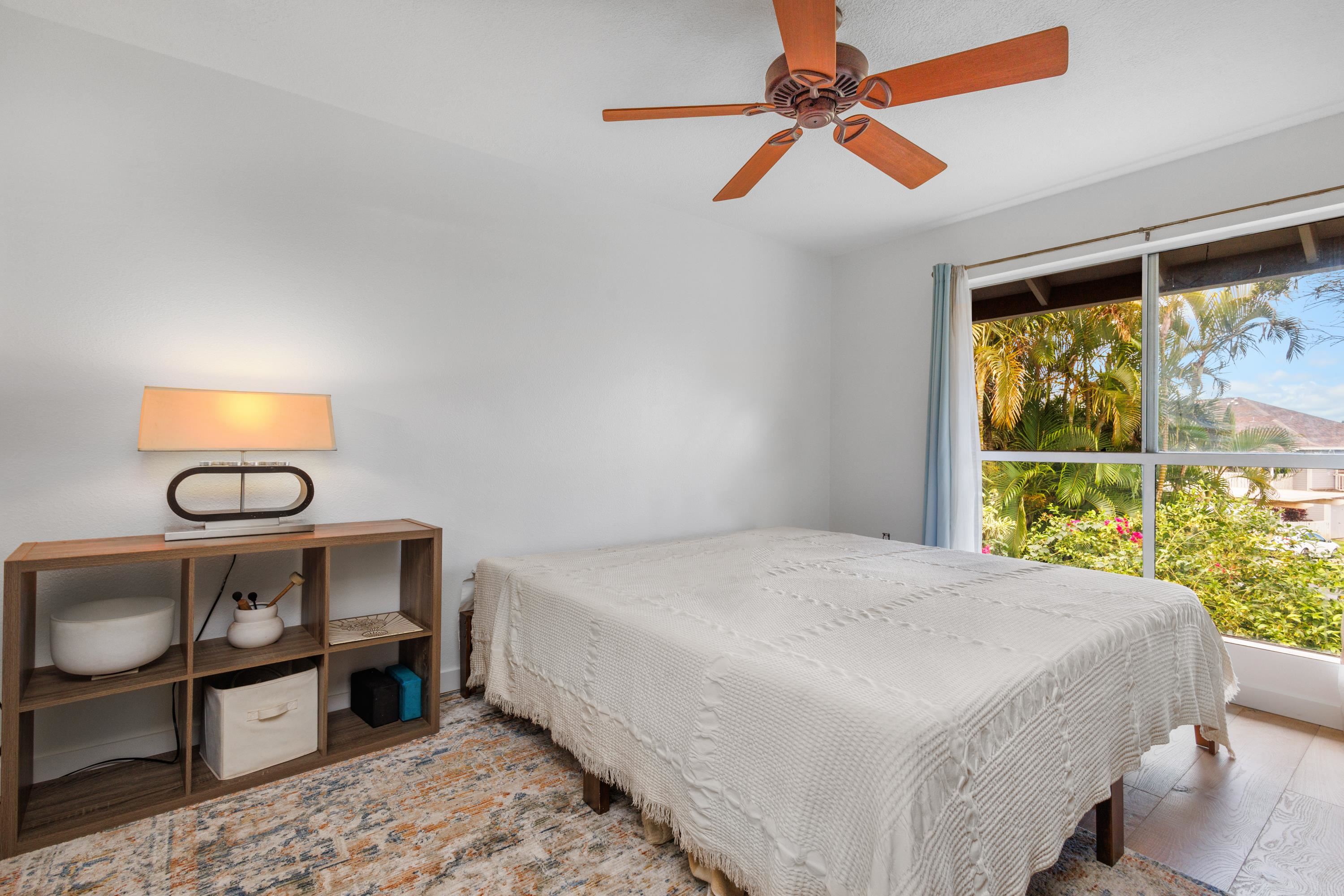 160 Keonekai Road, Unit 22201 Kihei, HI 96753 - Photo 22 of 37 a bedroom with a bed a chandelier and next to a window