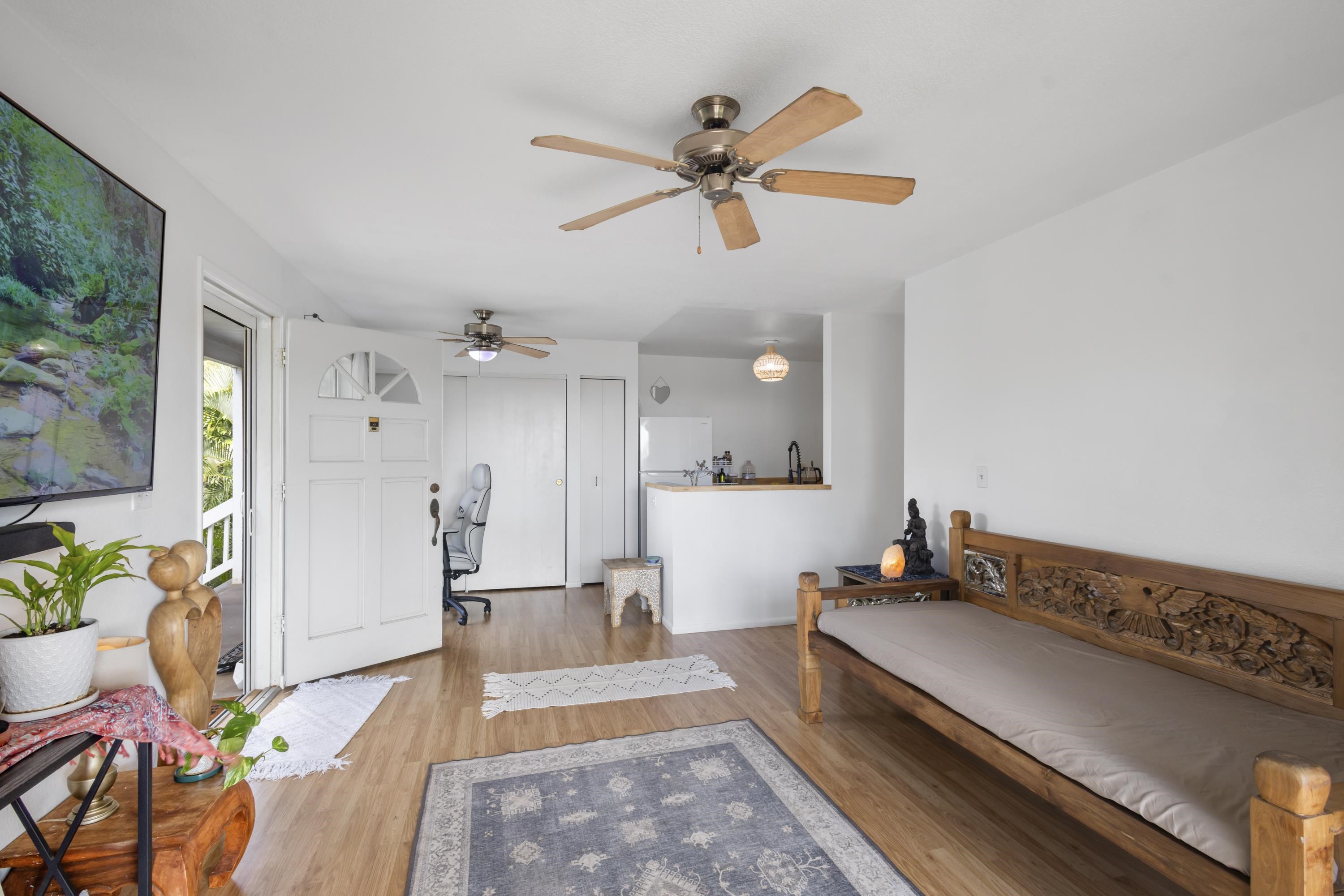160 Keonekai Road, Unit 22201 Kihei, HI 96753 - Photo 10 of 37 a living room with stainless steel appliances furniture a rug and a view of kitchen