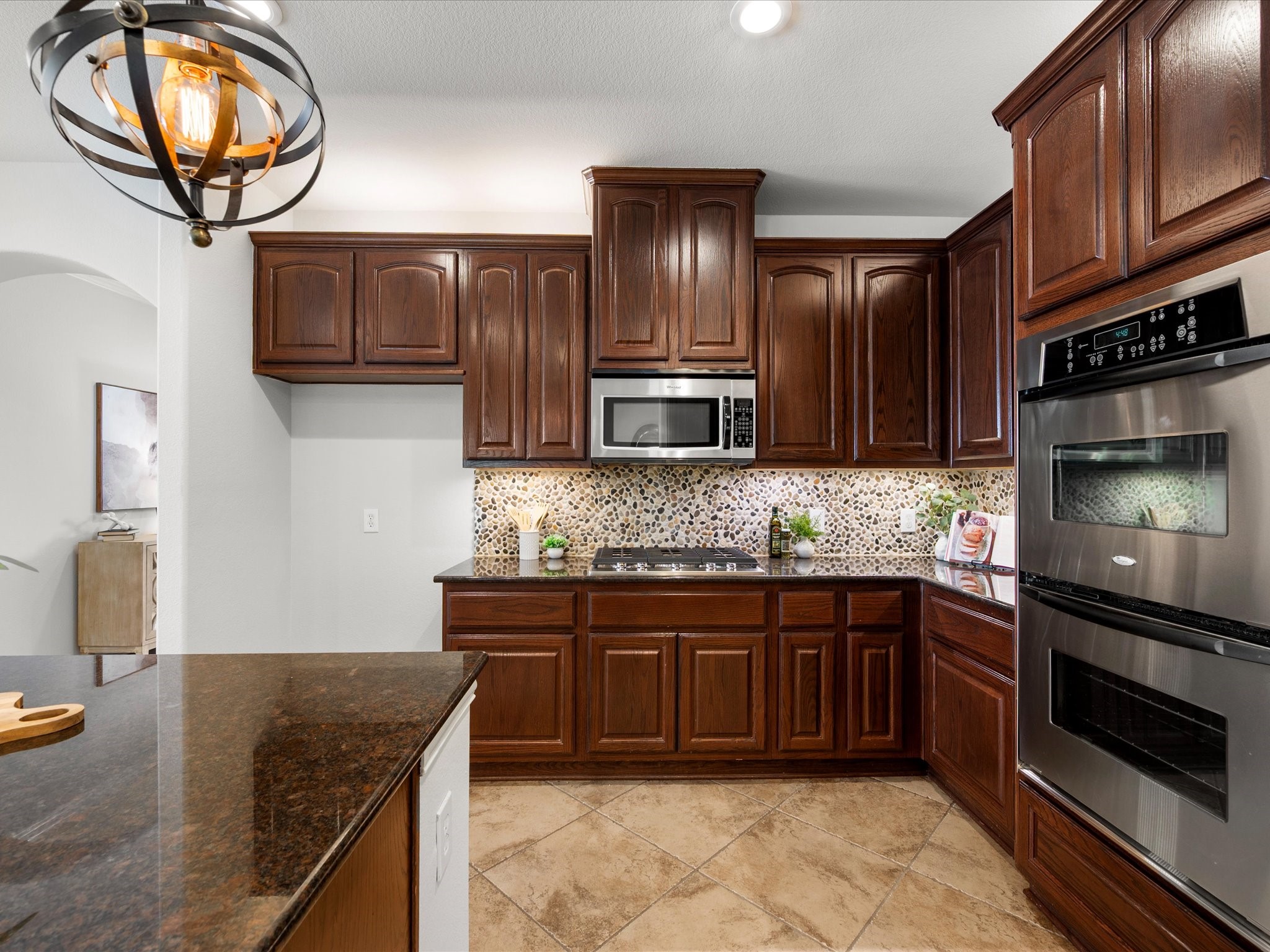 323 Arbor Ridge Lane Conroe, TX 77384 - Photo 9 of 40 KitchenAid double ovens and a gas cooktop for the people who actually use their kitchen. Storage everywhere, prep space for days. Thanksgiving just got a whole lot easier.