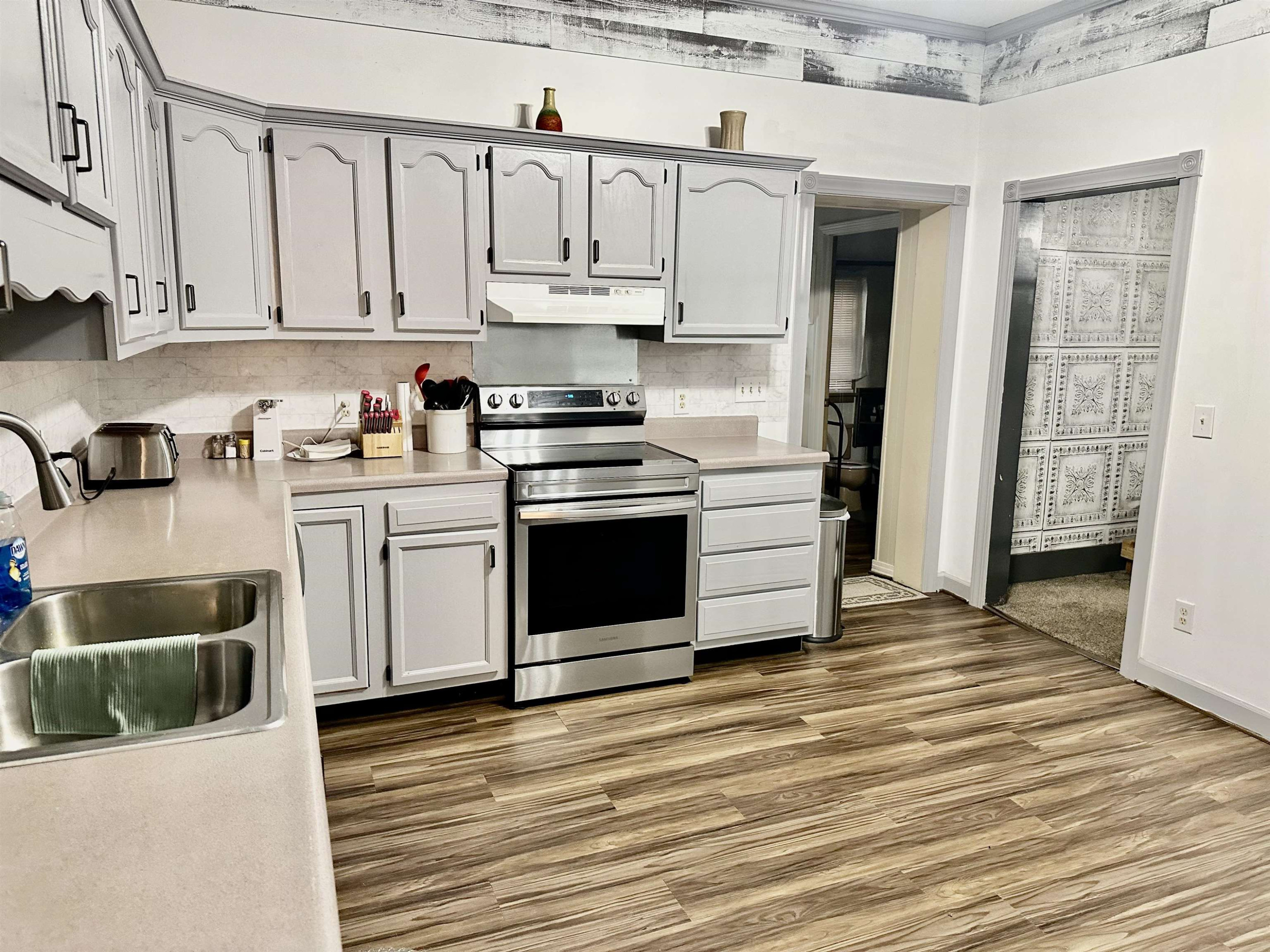 940 Lynn Point Road Greenfield, TN 38230 - Photo 8 of 14 a kitchen with stainless steel appliances granite countertop a stove and a refrigerator