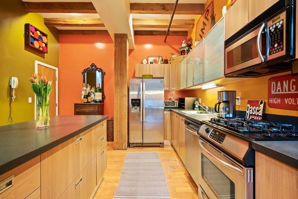 a kitchen with stainless steel appliances granite countertop a stove and cabinets