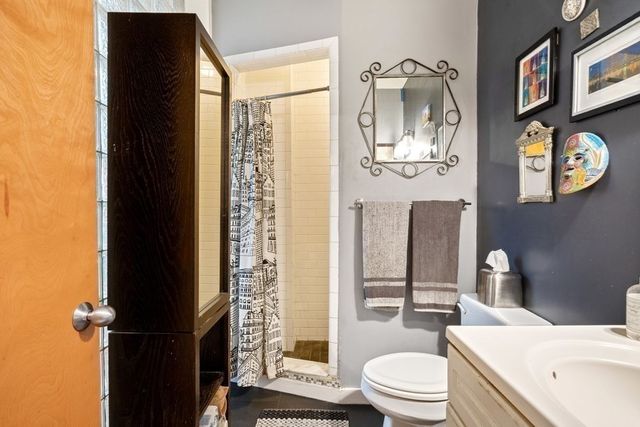 a white toilet sitting next to a bathroom sink and a tub
