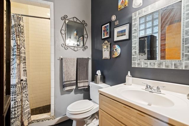 a bathroom with a sink a toilet and a mirror