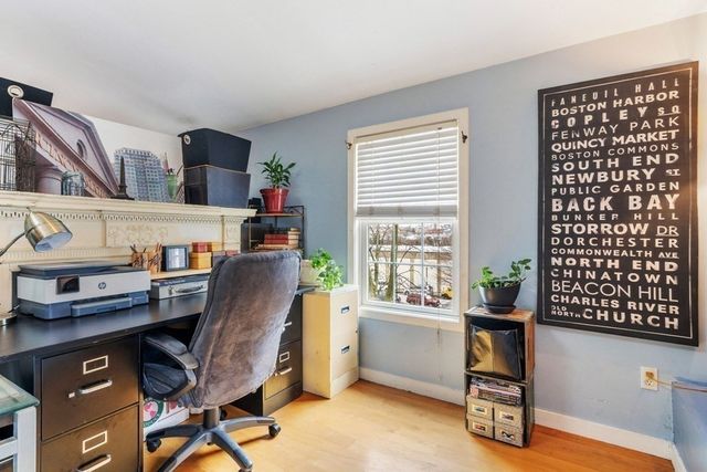 a view of a workspace with furniture and a window