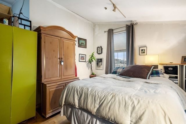 a bedroom with a bed and a dresser