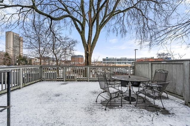 a view of a chair and table on the deck